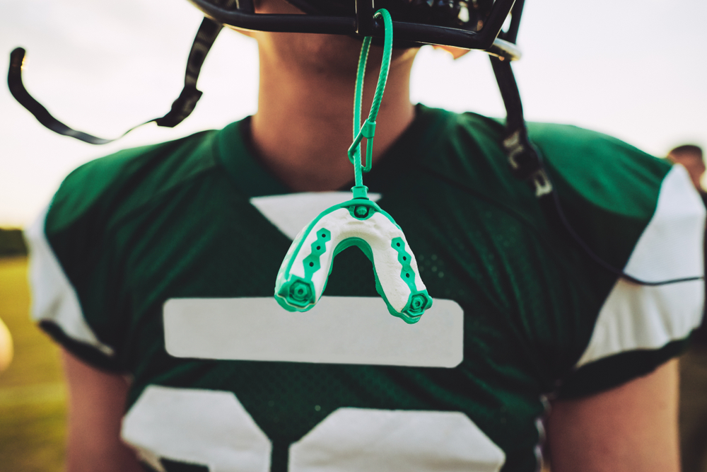 Closeup Of A Mouthguard Hanging Off The Helmet Of An